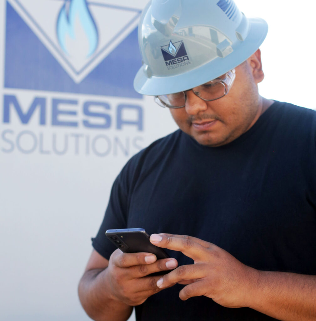 Mesa employee performing remote monitoring on mobile phone.