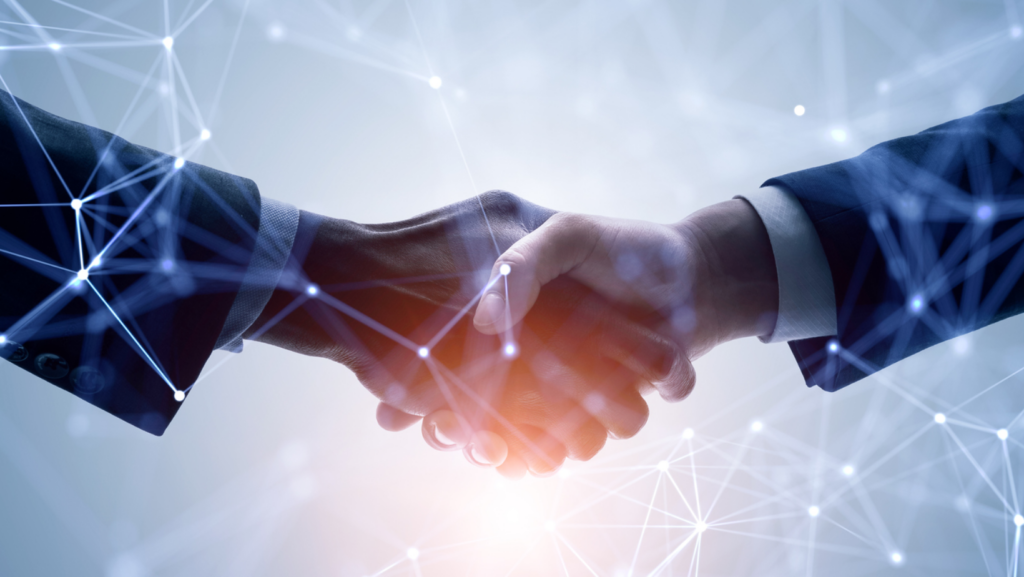 Empowering Success Through People, Innovation, and Partnerships. This picture portrays two hands shaking in partnership, highlighting the importance of innovative relationships with like-minded people ,organizations and industry leaders.