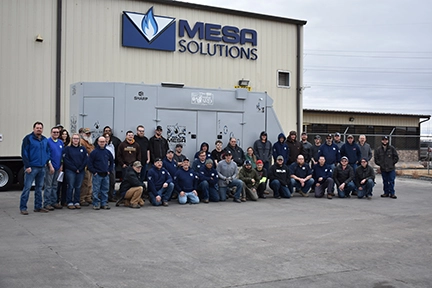 Mesa employees standing in front of Mesa's 1,000th generator edition.