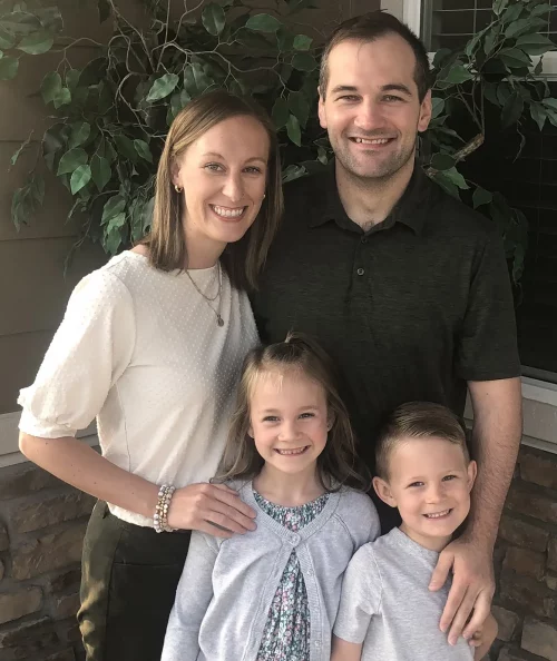 A Mesa employee and their family, posing for a family picture.